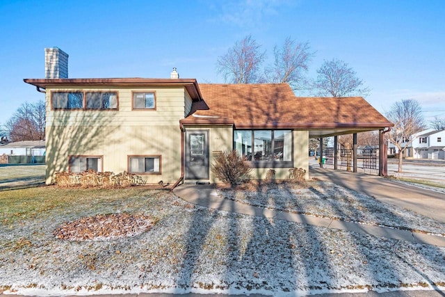 view of front of property featuring a carport