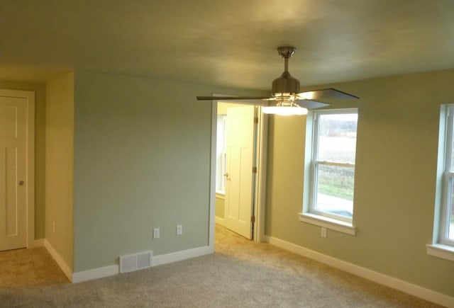 interior space featuring ceiling fan and light carpet