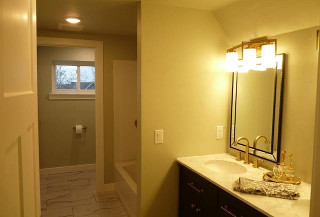 bathroom with vanity and lofted ceiling