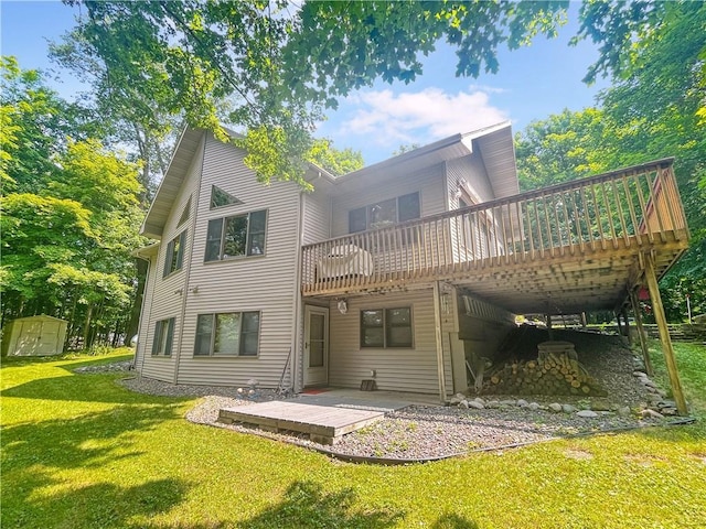 rear view of property featuring a lawn, a patio area, a shed, and a wooden deck