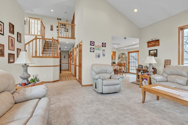 living room featuring light carpet, high vaulted ceiling, and a healthy amount of sunlight