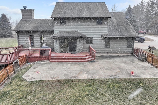 back of house featuring a patio, a lawn, and a wooden deck