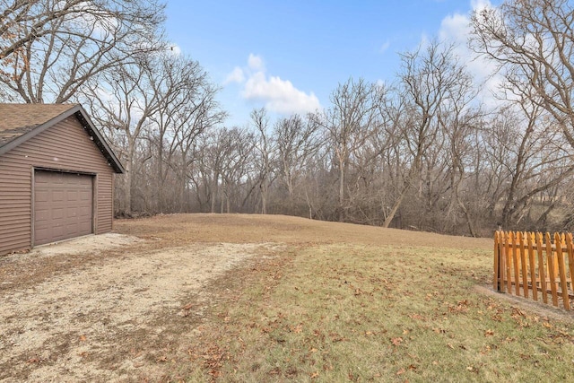 view of yard featuring an outbuilding and a garage