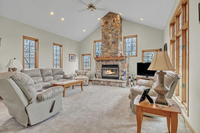 carpeted living room with a fireplace, high vaulted ceiling, and ceiling fan