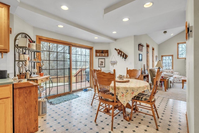 dining room featuring lofted ceiling and a wealth of natural light