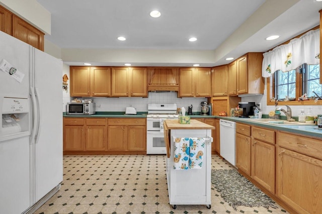 kitchen with a center island, white appliances, backsplash, premium range hood, and sink