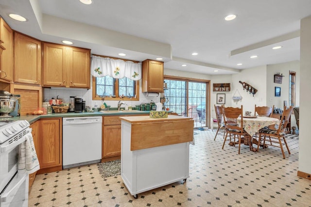 kitchen with tasteful backsplash, sink, and white appliances