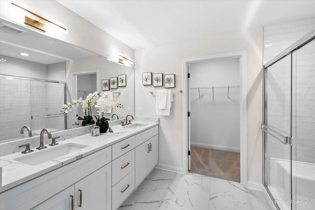 bathroom featuring vanity and a shower with shower door