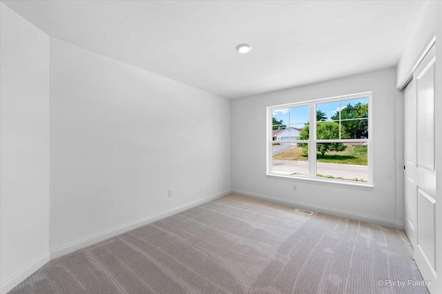 empty room with light colored carpet