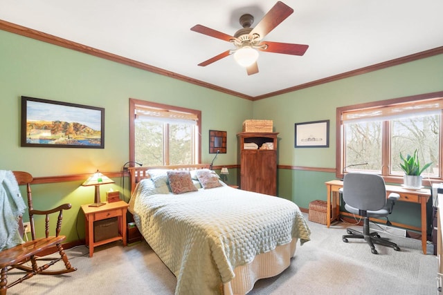 carpeted bedroom with ceiling fan and ornamental molding