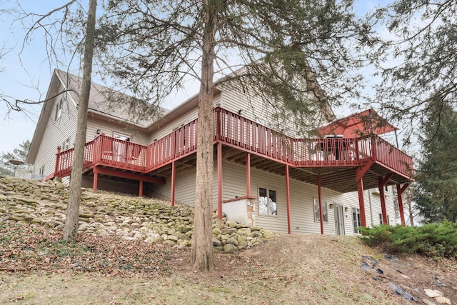 back of house with a wooden deck