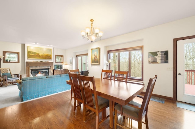 dining room featuring plenty of natural light, hardwood / wood-style floors, and an inviting chandelier