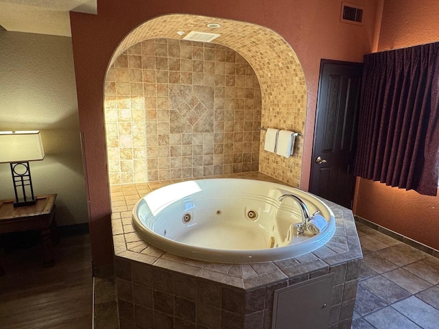 bathroom with tiled tub