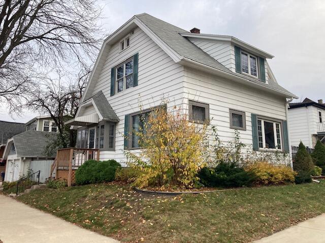 view of side of home featuring a lawn