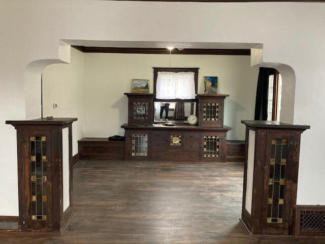 bar with dark hardwood / wood-style floors