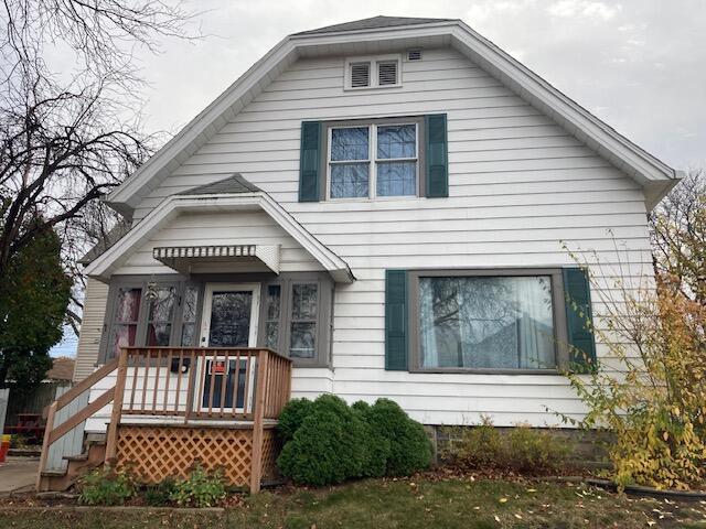 bungalow-style home with a front yard