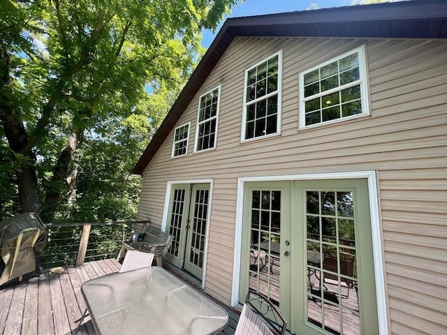 wooden deck featuring a grill and french doors