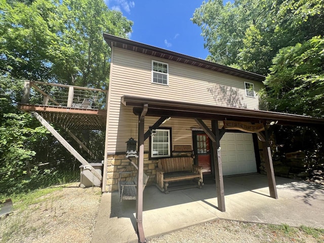 view of front facade with a garage and a wooden deck