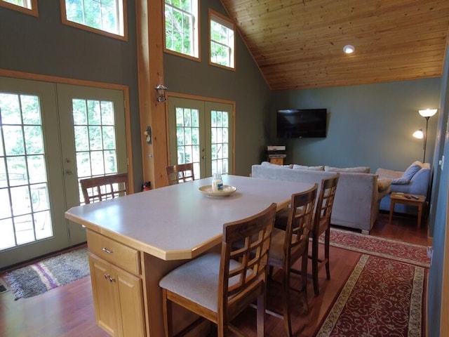 dining area with french doors, light hardwood / wood-style flooring, a wealth of natural light, and wood ceiling