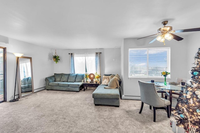 carpeted living room featuring baseboard heating and ceiling fan