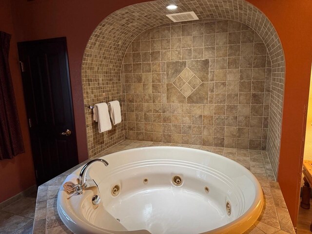 bathroom featuring tiled tub