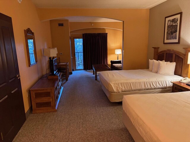 carpeted bedroom featuring access to exterior