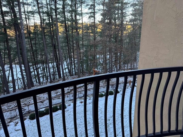 view of snow covered back of property