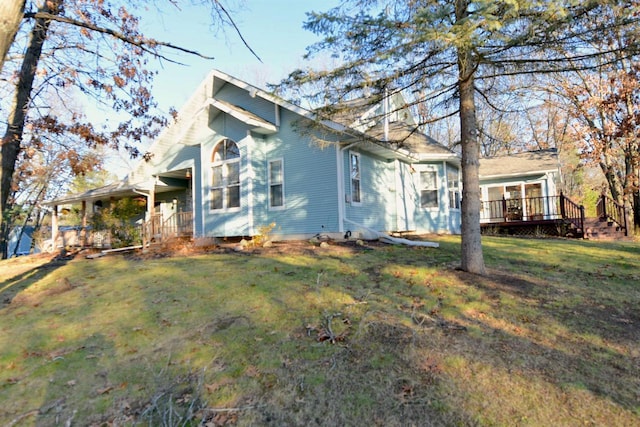 view of front of home featuring a front lawn and a deck