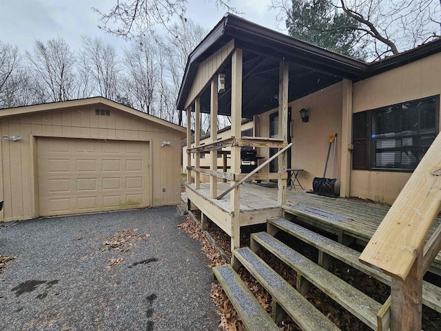 deck featuring an outdoor structure and a garage