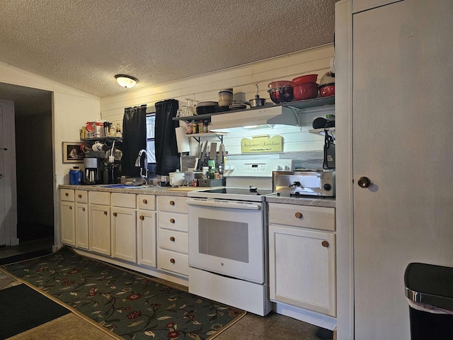 kitchen with white electric range oven, a textured ceiling, exhaust hood, sink, and lofted ceiling