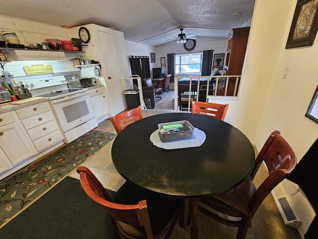 dining area featuring a textured ceiling, ceiling fan, and lofted ceiling