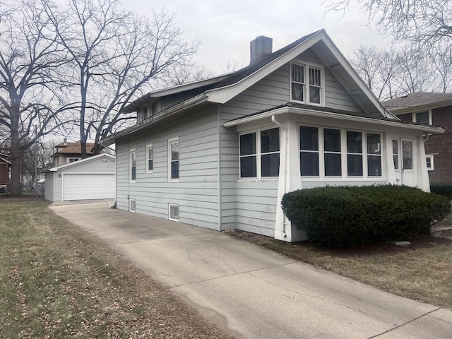 view of property exterior with a garage and an outdoor structure