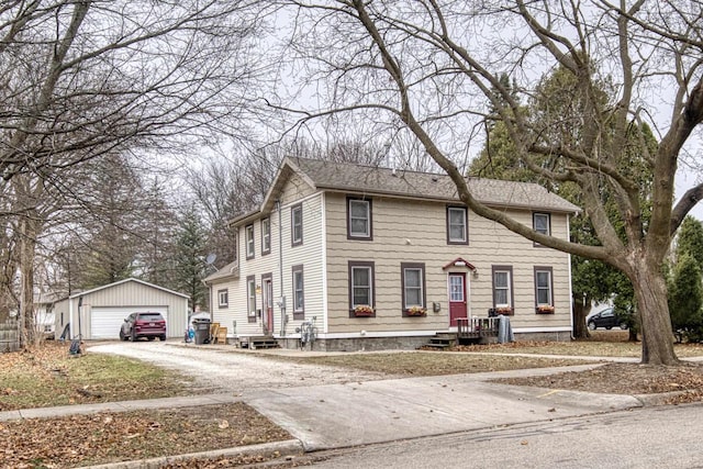 colonial inspired home featuring an outbuilding and a garage