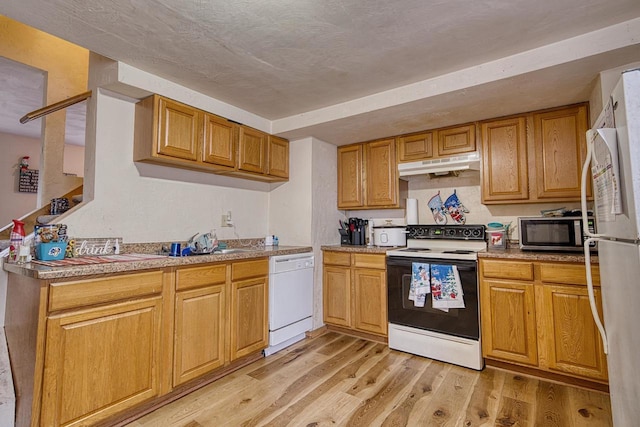 kitchen with light wood-type flooring and white appliances