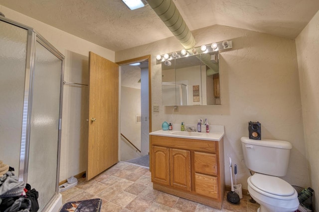 bathroom with vanity, toilet, walk in shower, and vaulted ceiling