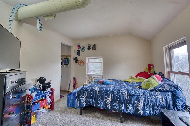 bedroom with carpet and lofted ceiling