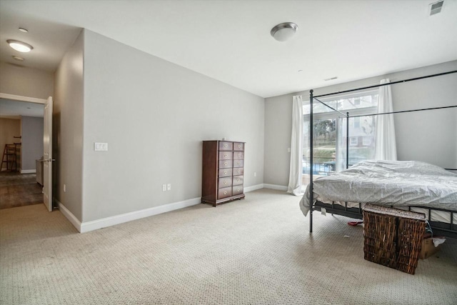 1925 N Water St Unit 100, Milwaukee, WI 53202 - bedroom with light carpet and access to exterior