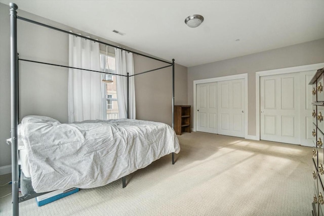 bedroom featuring light carpet