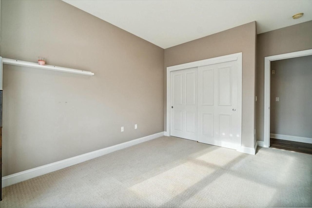 unfurnished bedroom featuring carpet floors and a closet