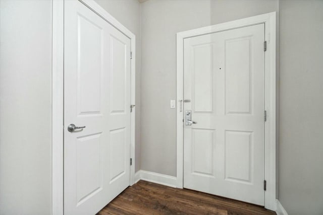 1925 N Water St Unit 100, Milwaukee, WI 53202 - doorway to outside featuring baseboards and dark wood-style floors