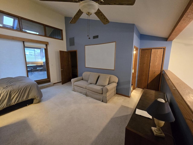 bedroom with ceiling fan, light colored carpet, and a high ceiling