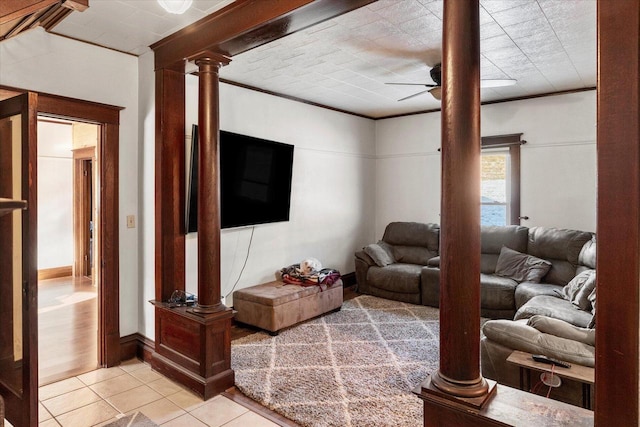 living room with ornate columns, ceiling fan, crown molding, and light tile patterned flooring