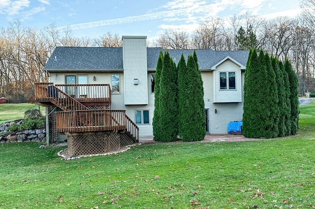 back of house featuring a yard and a wooden deck