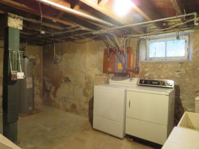 basement featuring washer and clothes dryer and water heater