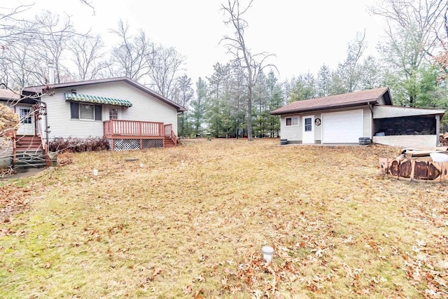 view of yard with an outbuilding and a wooden deck