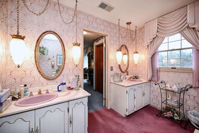 bathroom with vanity and a textured ceiling