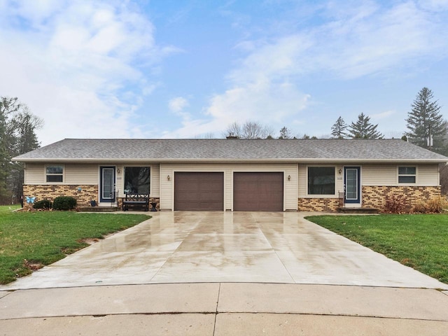 ranch-style home featuring a garage and a front lawn