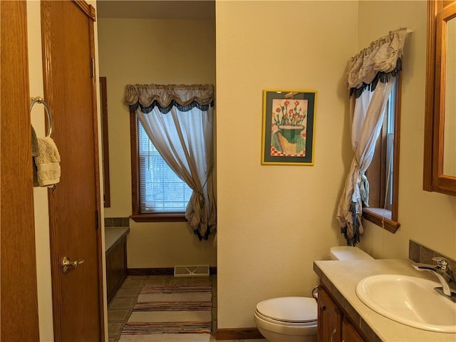 bathroom featuring tile patterned flooring, vanity, and toilet