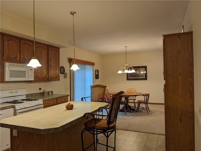 kitchen with light carpet, pendant lighting, white appliances, and a notable chandelier