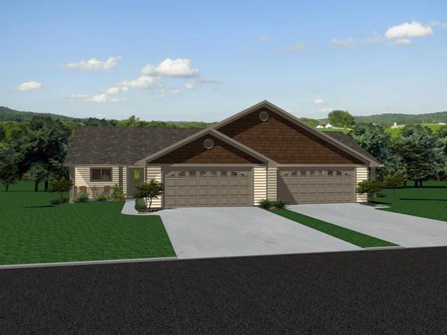 view of front of house featuring a garage, concrete driveway, and a front lawn